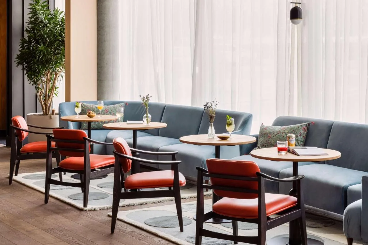 a restaurant with tables and chairs and a couch at Hyatt Centric Cambridge in Cambridge
